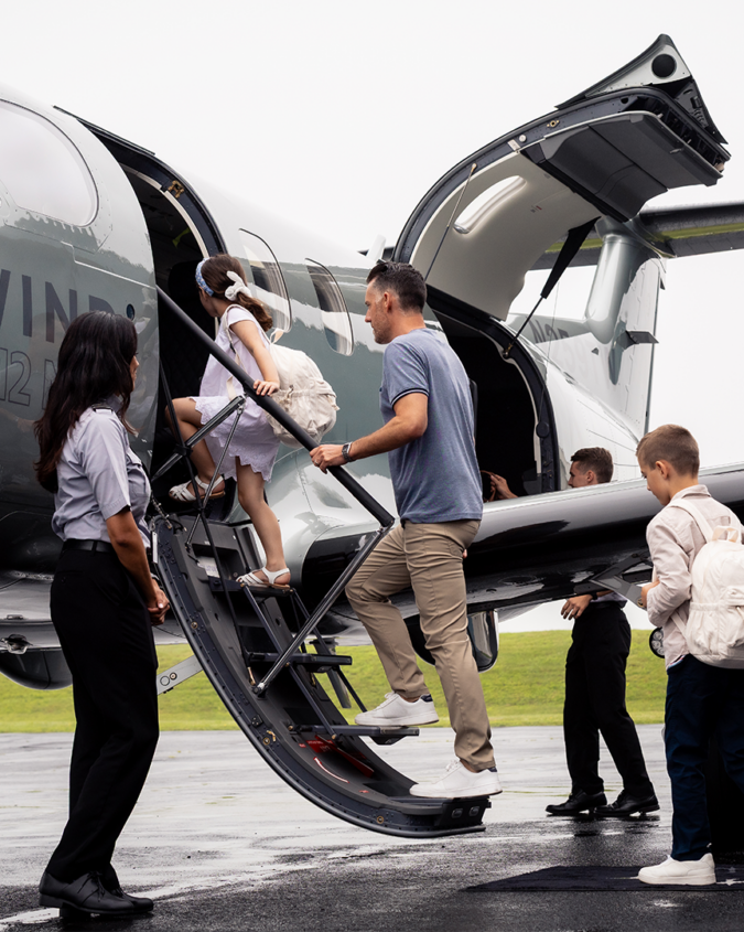 A family boarding a Tradewind plane showing how to get to Nantucket